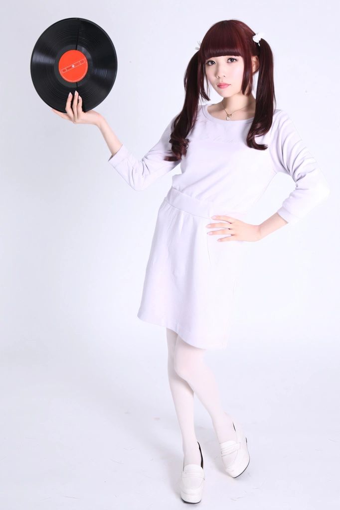 Portrait of a Brown Haired Japanese Woman Standing with a Vinyl Record, Photo