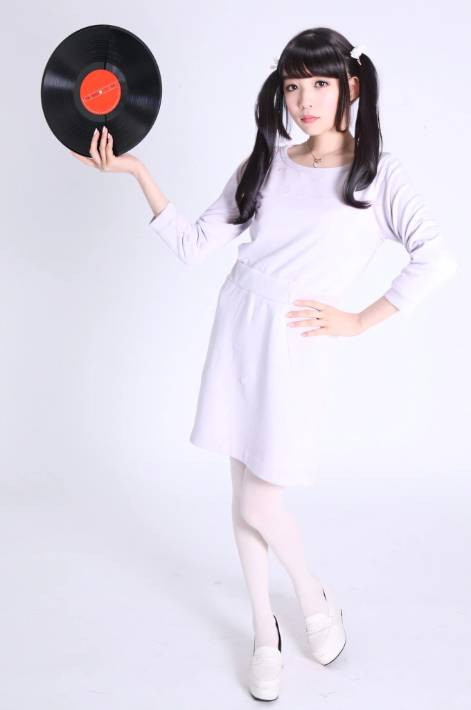 Portrait of a Black Haired Japanese Woman Standing with a Vinyl Record, Photo