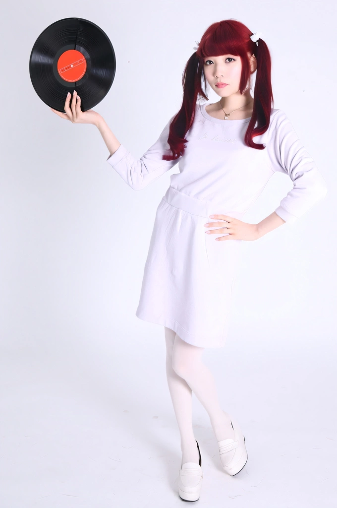 Portrait of a Red Haired Japanese Woman Standing with a Vinyl Record, Photo