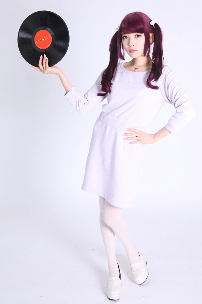 Portrait of a Pink Haired Japanese Woman Standing with a Vinyl Record, Photo