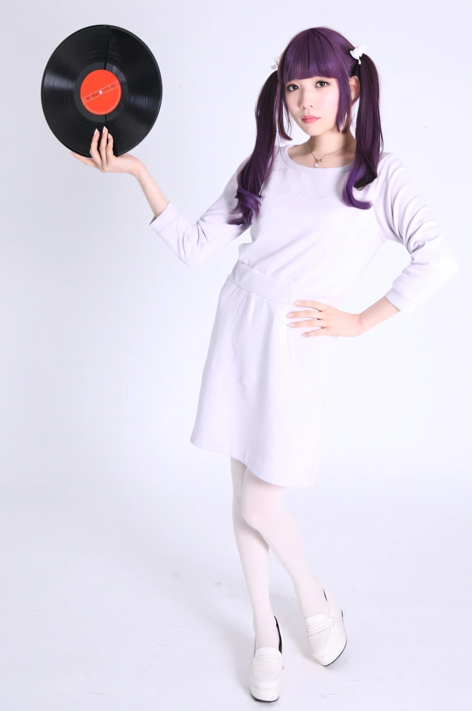 Portrait of a Purple Haired Japanese Woman Standing with a Vinyl Record, Photo