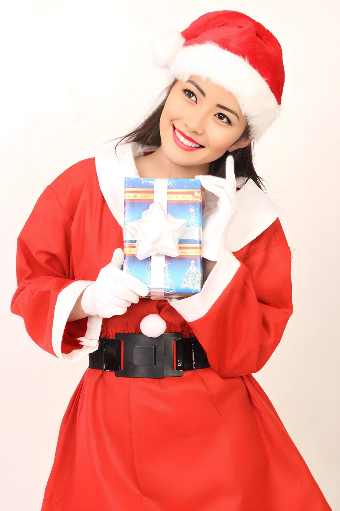 Portrait of an Asian Woman in a Santa Claus Costume Holding a Christmas Gift #2, Photo