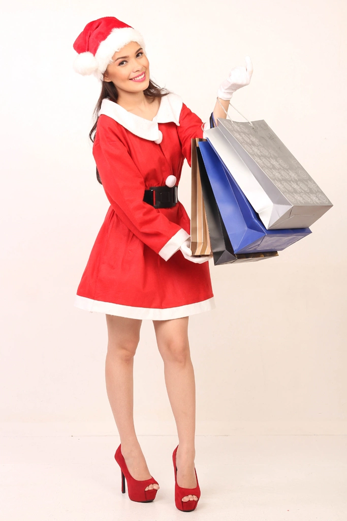 Portrait of an Asian Woman in Santa Costume After Christmas Sale Shopping, Photo